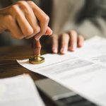 Close-up,Of,Person,Stamping,Documents,To,Approve,Agreements,